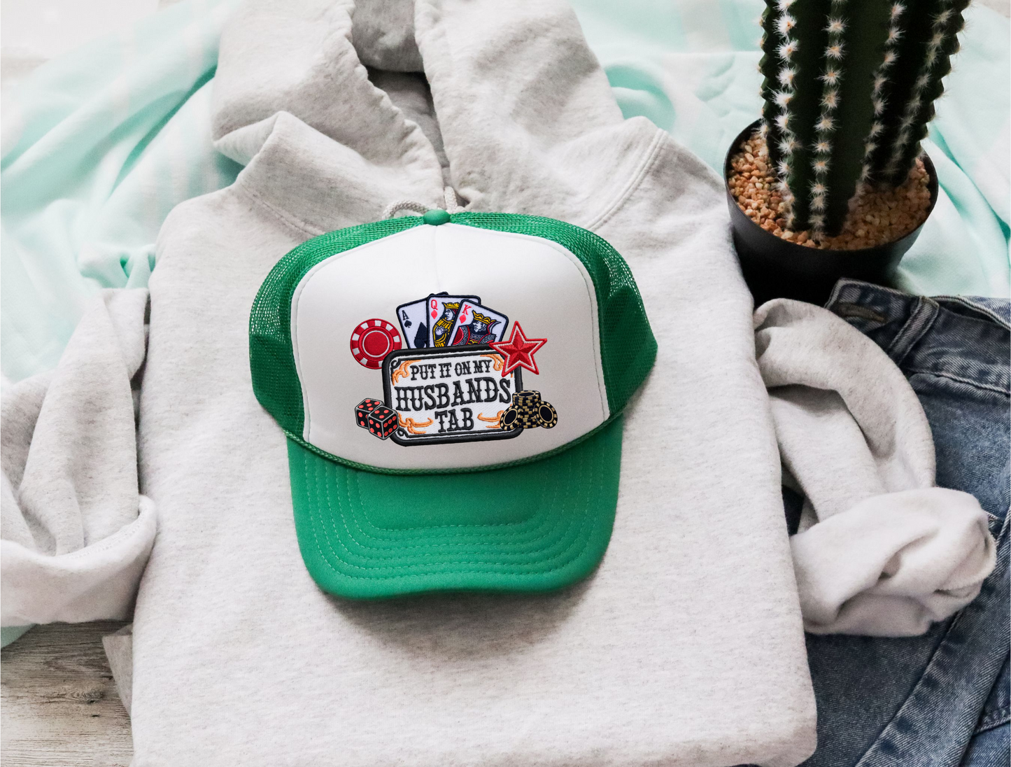 Put It On My Husbands Tab Trucker Hat